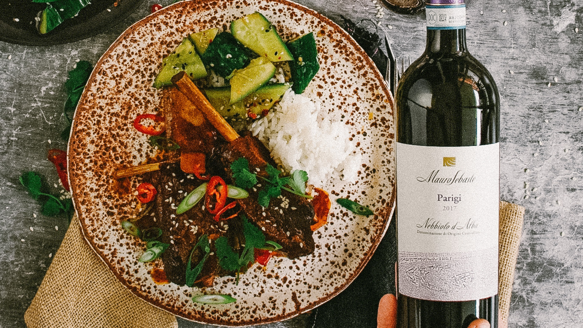 A meal of Asian Style Slow Cooked Ribs served with a bottle of Nebbiolo